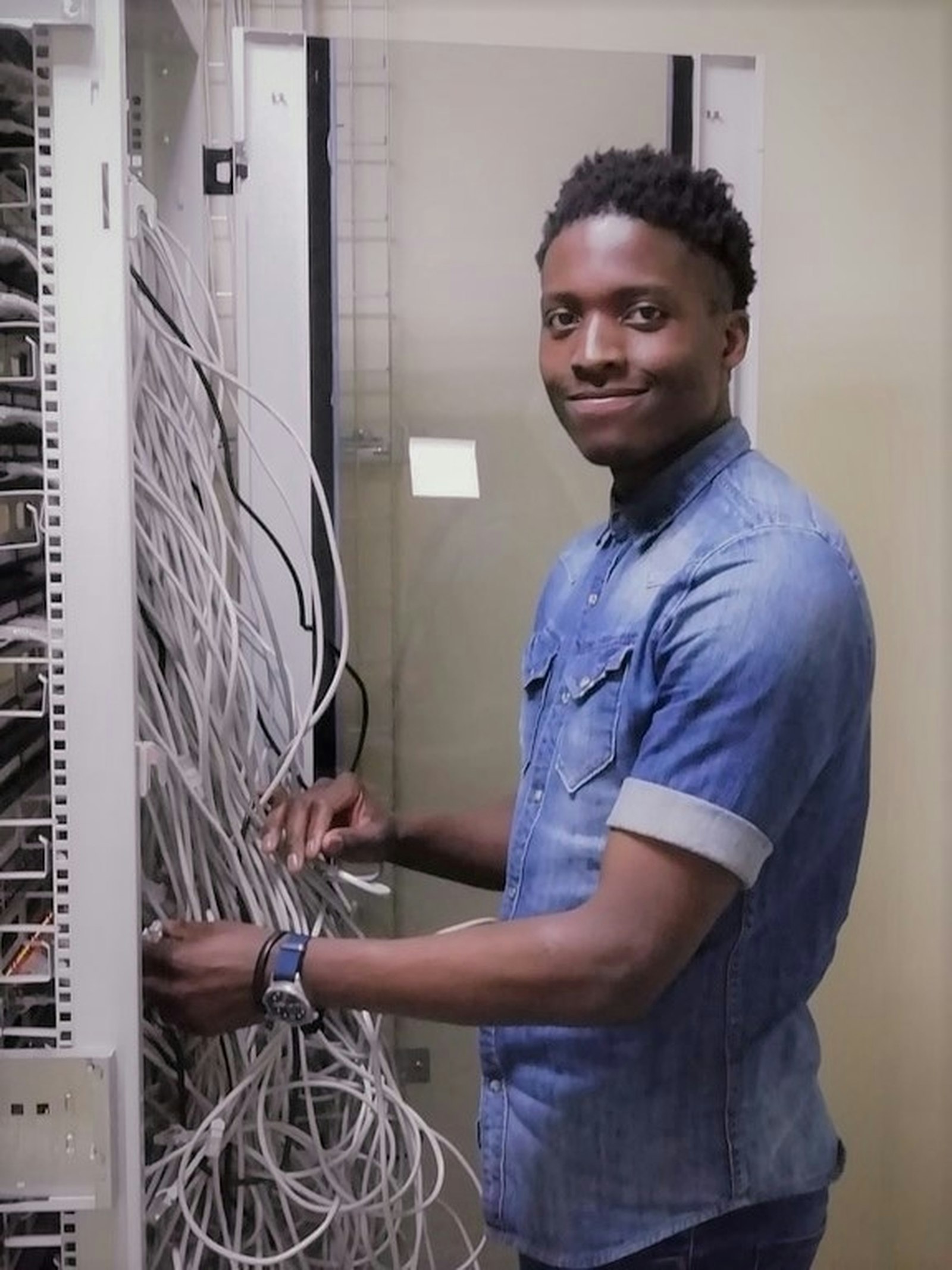 K7 IT Networks technician working on network cabling in a server rack